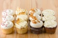 Variety Of Gourmet Cupcakes On Wooden Table