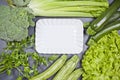 Variety of green vegetables and white ceramic plate Royalty Free Stock Photo