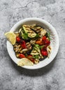 Variety grilled vegetables - eggplant, zucchini, pepper on a grey stone background, top view. Delicious appetizer, tapas, snack