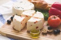 Variety of home made cheese and paprica and herbs,olive oil,olives and bread on a wooden board. brined curd white cheese Royalty Free Stock Photo