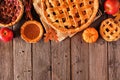 Variety of homemade autumn pies. Top border over a rustic wood background.