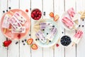 Variety of homemade berry yogurt popsicles, top view table scene over white wood Royalty Free Stock Photo