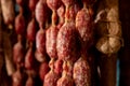 Variety of homemade dried salami sausages hanging in butchery shop in Parma, emilia Romagna, Italy