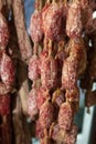 Variety of homemade dried salami sausages hanging in butchery shop in Parma, emilia Romagna, Italy