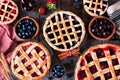 Variety of homemade fruit pies. Top view table scene over rustic wood.