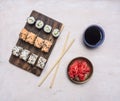 Variety of homemade sushi roll with cucumber, salmon and crab with soy sauce and ginger , Asian cuisine wooden rustic backgrou