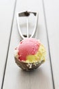 A variety of ice cream in a scoop, vanilla and strawberries