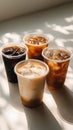 Variety of iced coffee drinks displayed on a bright surface with interesting shadows Royalty Free Stock Photo