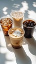 Variety of iced coffee drinks displayed on a bright surface with interesting shadows Royalty Free Stock Photo