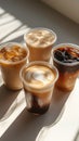 Variety of iced coffee drinks displayed on a bright surface with interesting shadows Royalty Free Stock Photo