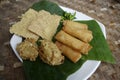 Variety of indonesian famous snacks also known as Gorengan. Served on banana leaf and white plate.