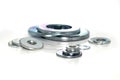 Variety of industrial galvanized steel washers on white