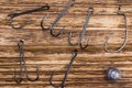 Variety of iron fishing hooks on a wooden burnt background Royalty Free Stock Photo