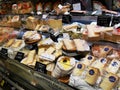 Variety of Italian cheeses on shelves.