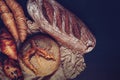 Variety kinds of bread on wooden plank in dark tone - Image