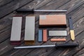 A variety of knife sharpeners. Sharpening stones and devices on a wooden background. Grinding stones