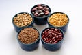 A variety of legumes. Lentils, chickpeas, peas and beans in blue bowls on a white background. Close-up Royalty Free Stock Photo