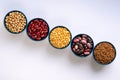 A variety of legumes. Lentils, chickpeas, peas and beans in blue bowls on a white background. Top view Royalty Free Stock Photo