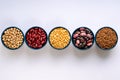 A variety of legumes. Lentils, chickpeas, peas and beans in blue bowls on a white background. Top view Royalty Free Stock Photo
