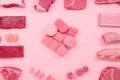 A variety of meats and meat cubes on a pink background. AI generative image