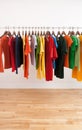 Variety of multicolored clothes on a rod