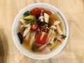 Variety mushrooms in spicy and sour clear lemongrass soup.
