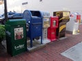 A variety of newspaper stands and mailboxes located on a city street in Knoxville