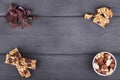 Variety of nuts, granola bars and chocolate on wooden background Royalty Free Stock Photo