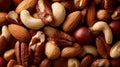 Assorted nuts including almonds, cashews, pecans, and hazelnuts in a close-up arrangement on a wooden surface Royalty Free Stock Photo