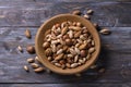Variety of nuts in wooden bowl over wooden table. almonds, walnuts, hazelnuts, pistachios Royalty Free Stock Photo