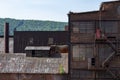 A variety of old industrial buildings with brick, corrugated metal, and glass Royalty Free Stock Photo