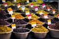 Variety of olives for sale on Suq arabic price tags