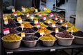 Variety of olives for sale on Suq arabic price tags