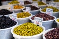 Variety of olives for sale on Suq arabic price tags