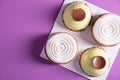 a variety of original cakes top view boxes on a purple background, culinary