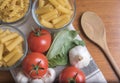 Variety of pasta with tomatoes, basil, mushrooms and garlic Royalty Free Stock Photo