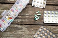 Variety of pills in white plastic pill organizer on weathered wood Royalty Free Stock Photo