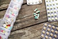 Variety of pills in white plastic pill organizer on weathered wood Royalty Free Stock Photo