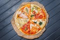 A variety of pizzas lie on a wooden table. view from above.