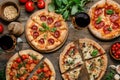 Assorted Italian Pizzas on Wooden Table