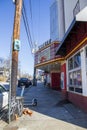 The Variety Playhouse surrounded by power lines with cars parked along the street and people on the sidewalk and a clear blue sky