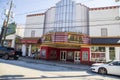 The Variety Playhouse surrounded by power lines with cars parked along the street and people on the sidewalk and a clear blue sky