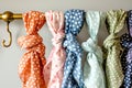 a variety of polkadotted spring scarves on a brass rack