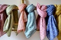 a variety of polkadotted spring scarves on a brass rack