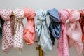 a variety of polkadotted spring scarves on a brass rack