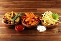 Variety of potatoes with fries. potato wedges, french fries, sweet potato for lunch on table Royalty Free Stock Photo