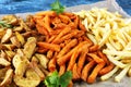 Variety of potatoes with fries. potato wedges, french fries, sweet potato for lunch on table Royalty Free Stock Photo