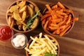 Variety of potatoes with fries. potato wedges, french fries, sweet potato for lunch on table