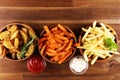 Variety of potatoes with fries. potato wedges, french fries, sweet potato for lunch on table Royalty Free Stock Photo