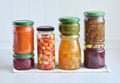 Variety of preserved food in glass jars - pickles, jam, marmalade, sauces, ketchup. Preserving vegetables and fruits. Fermented fo Royalty Free Stock Photo